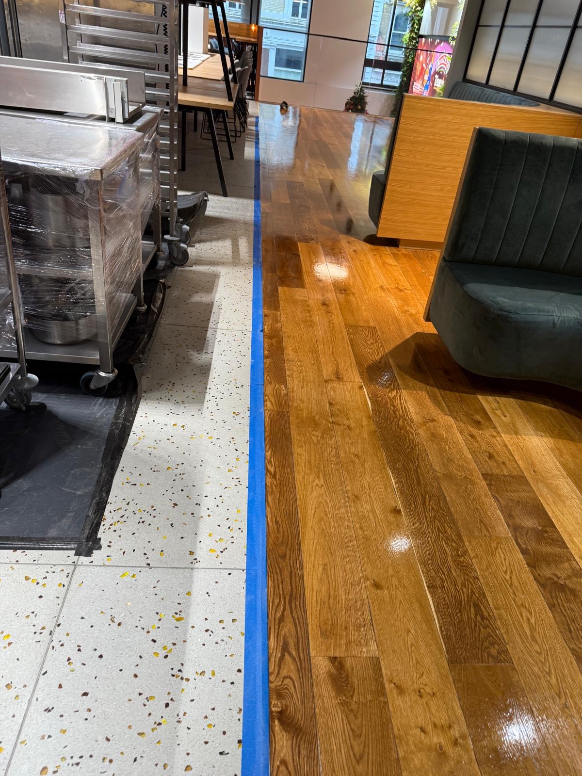 Transformed timber floor next to protected ceramics post oil application - Loughton Direct