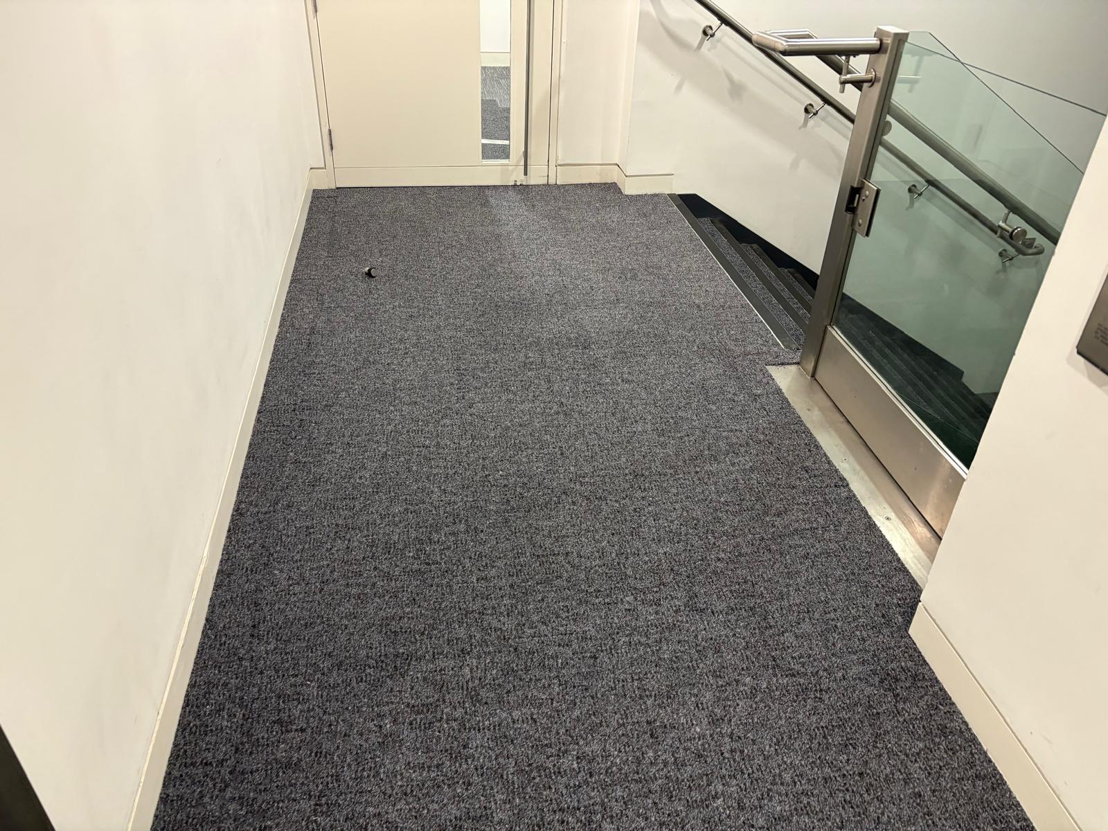 Stairwell area with new Milliken entrance matting tiles - Loughton Direct 