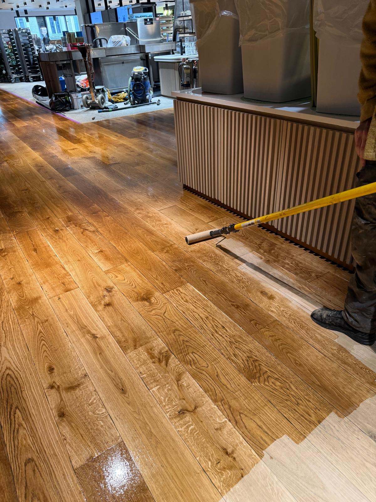 Oil wax being applied to the timber for restoration - Loughton Direct